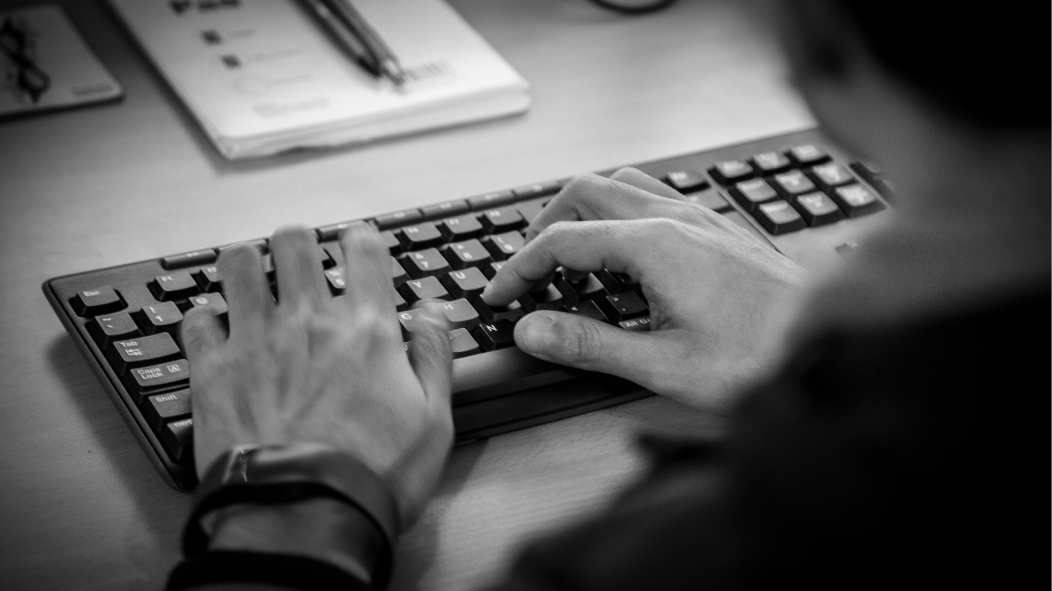 close up of someone typing on a computer keyboard